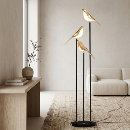 Lampada da terra in metallo nero con tre uccelli luminosi color oro