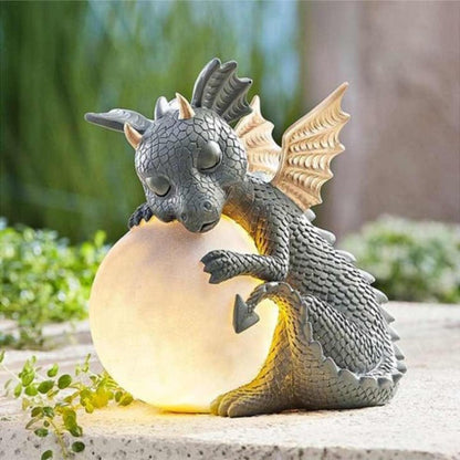 Statua da giardino a forma di drago con globo luminoso solare