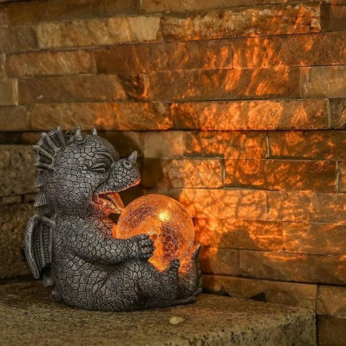 Statua da giardino a forma di drago con globo luminoso solare